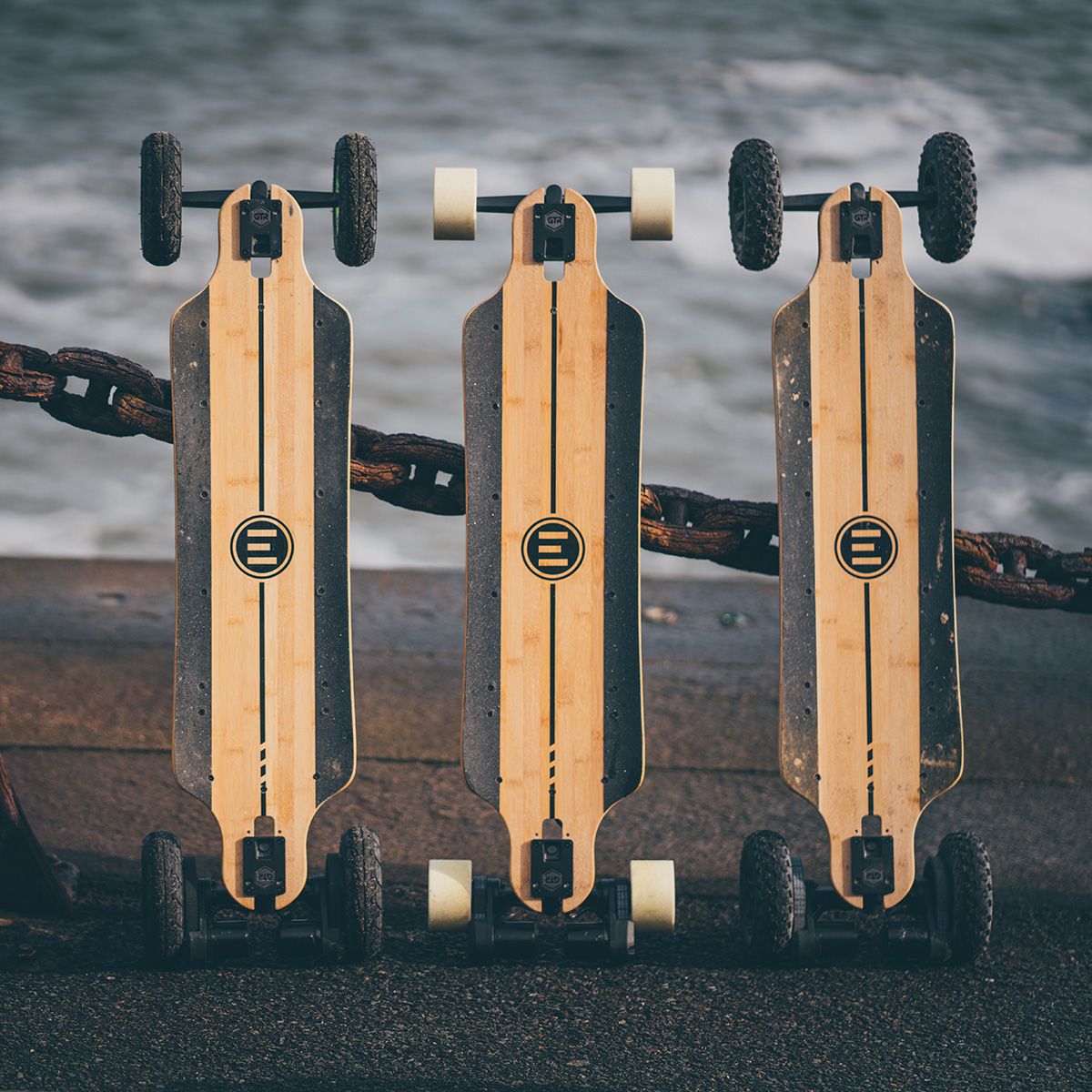 Three Evolve electric skateboards